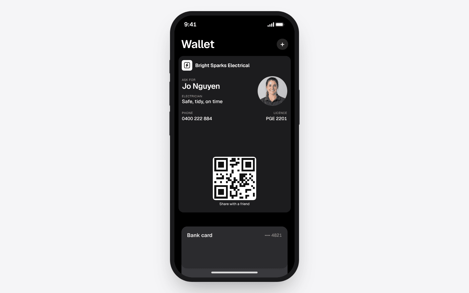 An electrician's business card saved as a pass in Apple Wallet on an iPhone, sitting above the owner's other cards